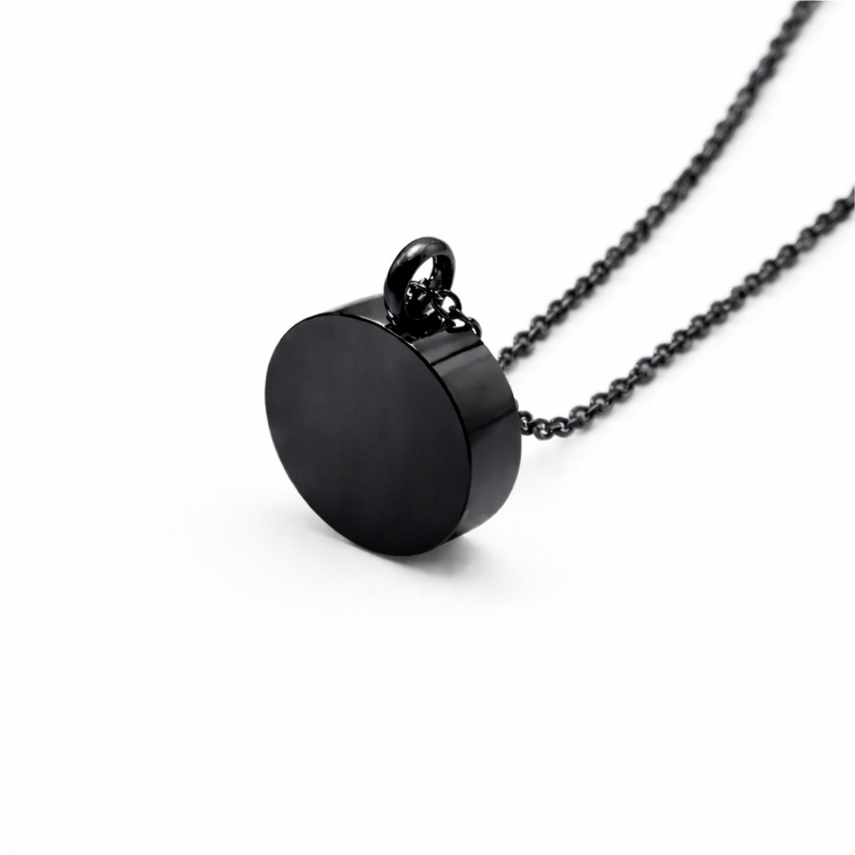 Vue 3/4 du pendentif cercle éternel urne en acier inoxydable noir mettant en valeur sa silhouette ronde et son compartiment intégré
