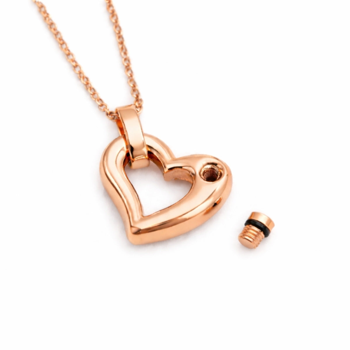 Détail du compartiment interne sécurisé du pendentif cœur éternel urne rose avec fermeture à vis