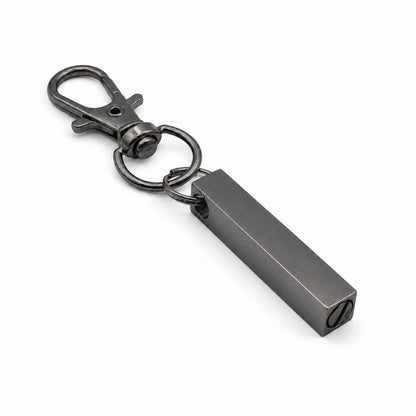 Vue 3/4 du porte-clés Écrin du Souvenir urne en acier inoxydable noir avec mousqueton et compartiment souvenir