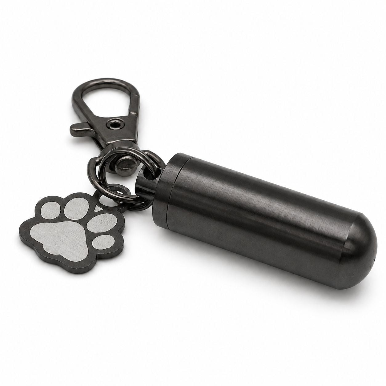 Vue 3/4 du porte-clés Empreinte du Souvenir urne en acier inoxydable noir avec pendentif patte et cylindre souvenir